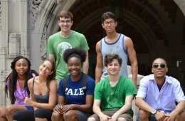A group of students posed in front of an archway