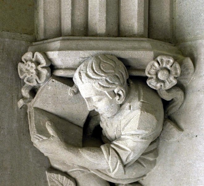 Stone Carving of Student Reading Sterling Memorial Library